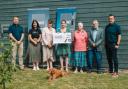 WightAID donors Paul Thomas (far left), of Isle of Wight Tomatoes and Paul Thorley (far right), of Vehicle Consulting Solent with representatives of some of the grant recipients, and Mavis, the WightAID dog
