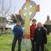 The Celtic mosaic cross with, from left, Ali Mascarenhas, and Dave and Miriam Crewe from the Brighstone mosaic group.
