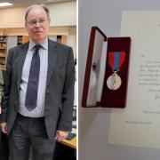 Richard Marshall, holding the Imperial Service Medal and citation, with district judge Andrew Grand, who presented them to him.