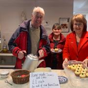Barbara Conway (right) and Newport parishioners selling cakes after Sunday Mass to raise money for their youth group.