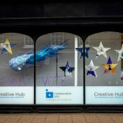 Front window with work from The Island Learning centre students and Independent Arts Creative hub.