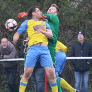 Newport's skipper, Martin McDonough, in a tussle with the Frimley Green's keeper