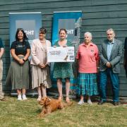 WightAID donors Paul Thomas (far left), of Isle of Wight Tomatoes and Paul Thorley (far right), of Vehicle Consulting Solent with representatives of some of the grant recipients, and Mavis, the WightAID dog