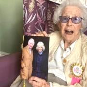 Centenarian, Betty Cory, holds her special card from King Charles and Queen Camilla
