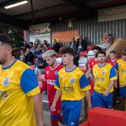 Newport and Aldershot walk out onto the field.