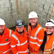 Standing in front of one of the massive new storm tanks are, from left, Dan Attrill, of C45, Steve Burton, of Wight Building Materials, John Pitfield, of Galliford Try, and Cameron Davies, of Active Tunnelling.