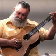 Paul Armfield performing a song at Yarnival 2024.