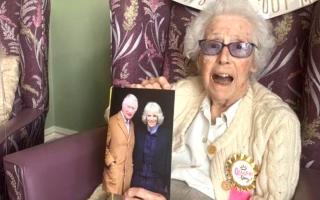 Centenarian, Betty Cory, holds her special card from King Charles and Queen Camilla