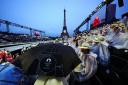 Spectators shelter from the rain at the Trocadero during the Paris Olympics opening ceremony (Mike Egerton/PA).
