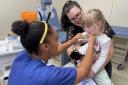 A child gets her flu vaccine in time for Halloween.