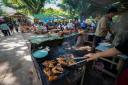 People relax with beer and food in Vang Vieng, Laos (AP Photo/Anupam Nath)