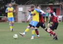 Macauley Waterson holds off a Romsey forward