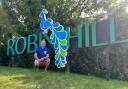 Lee Priddle, in front of the Robin Hill sign.