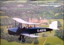 One of the Spartan bi-planes built on the Island, flying over Osborne House.