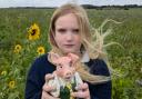 Nine-year-old Scarlett Maddison-Wigg with her piggy bank.