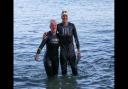 Crys and swim buddy Holly Bartley arrive at Colwell Bay and celebrate finishing the swim