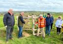 High Sheriff Graham Biss opening the new gate, alongside Will Myles, managing director of Visit IW, left, and David Howarth from the Ramblers