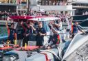 The INEOS Britannia team and British fans celebrate an excellent day in the America's Cup in Barcelona.