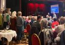 Derek, left, singing the song he wrote about his wife and dementia, with pianist Richard Britton conducting. The choir and volunteers are backing singers