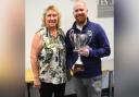 Tom Dye receives an award from Isle of Wight Cricket Board director Kate Barton.