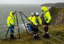 A Coastguard rescue team in training for a cliff rescue.