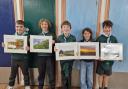 Jake, Eli, George, Megan and Oscar with their photographs.