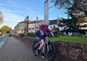 Maggie on her bike at the bus stop