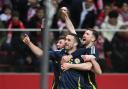 John McGinn, front, celebrates his Scotland goal in Warsaw (Rafal Oleksiewicz/PA)