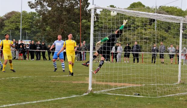 Isle of Wight County Press: Newport keeper Joe McCormack is unable to keep out a free kick which flicked off the head of Scott Sampson as an own goal. Photo: Barbara Close 