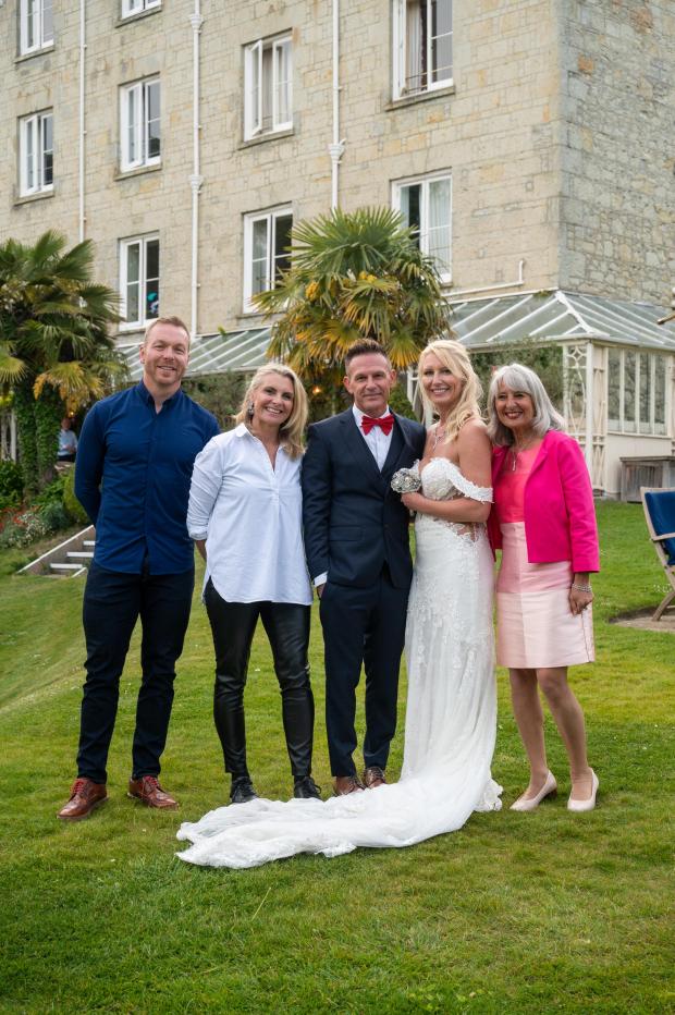 Isle of Wight County Press: Roy Foley and Mandy Schutt married on the Isle of Wight while on the LeBlanq tour. Far left, Sir Chris Hoy joins the happy couple. Far right is celebrant Elaine Cesar. Pictures by Stephanie Mackrill. 