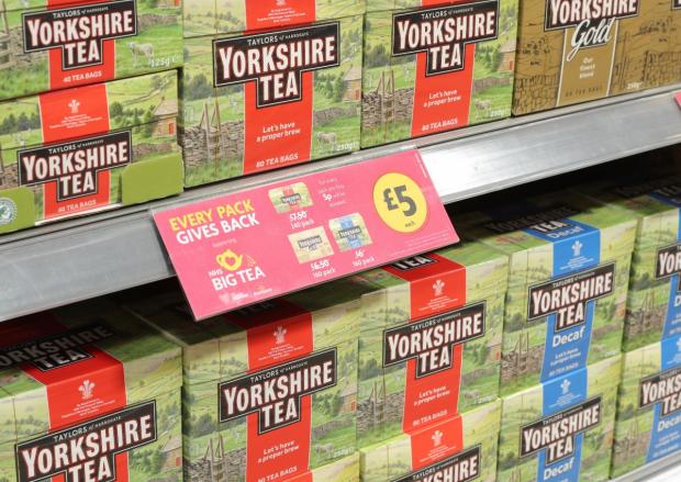 Isle of Wight County Press: Teabags on shelves and a Every Pack Gives Back label at a Morrisons store (Morrisons)