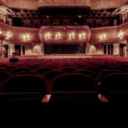 A grand theatre with rows of empty seats. Credit: Canva