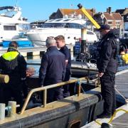 Police on board the seized boat Yvonne T in Yarmouth on Sunday.