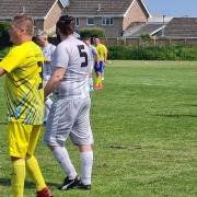 Isle of Wight Man v Fat in action at Bembridge's Steyne Park, wearing yellow, earlier this year