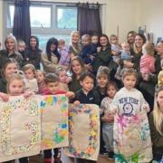 Staff and children at Tops Day Nurseries in Newport, celebrating the'Good' news.