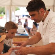 Chris Bavin with young Great Wight Bite visitors, in 2023.