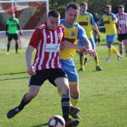East Cowes Vics' Raff Boyd-Kerr sees off challenge from Port's Joe Butcher in the derby on Good Friday