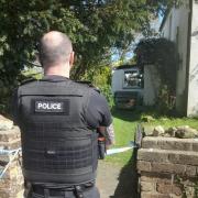 A police officer at the property near Godshill