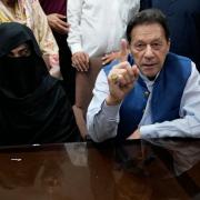 Imran Khan and his wife Bushra Bibi speaking to the media at an office of Lahore High Court in Lahore, Pakistan, in 2023 (KM Chaudary/AP)