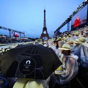 Spectators shelter from the rain at the Trocadero during the Paris Olympics opening ceremony (Mike Egerton/PA).