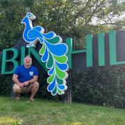 Lee Priddle, in front of the Robin Hill sign.