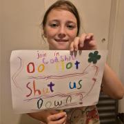 Godshill Primary School student, Lacey Dupré, nine, holding a banner she made.