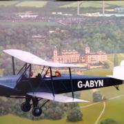 One of the Spartan bi-planes built on the Island, flying over Osborne House.