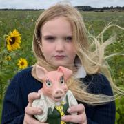 Nine-year-old Scarlett Maddison-Wigg with her piggy bank.