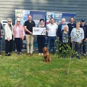 Geoff Underwood, founder and chairman of WightAID, left, with trustees and representatives of Island causes which received donations.