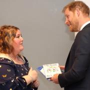 Islander Angela Turner shares a light moment with Prince Harry.