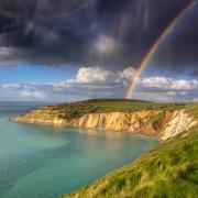 A bright evening rainbow over Alum Bay.