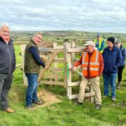 High Sheriff Graham Biss opening the new gate, alongside Will Myles, managing director of Visit IW, left, and David Howarth from the Ramblers