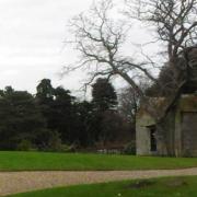 The construction, also known as 'The Bothy', is attached to a large Grade II listed wall.