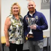 Tom Dye receives an award from Isle of Wight Cricket Board director Kate Barton.